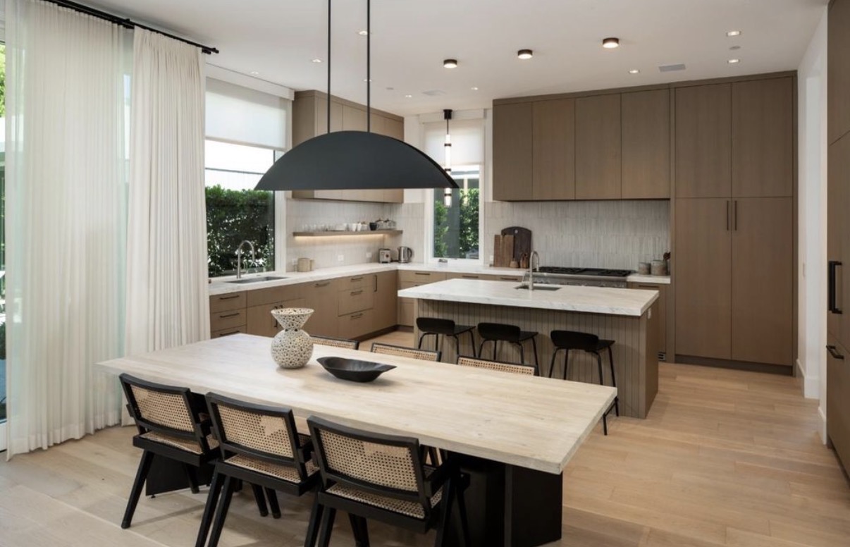 Warm custom kitchen and dining room with sculptural pendant lighting
