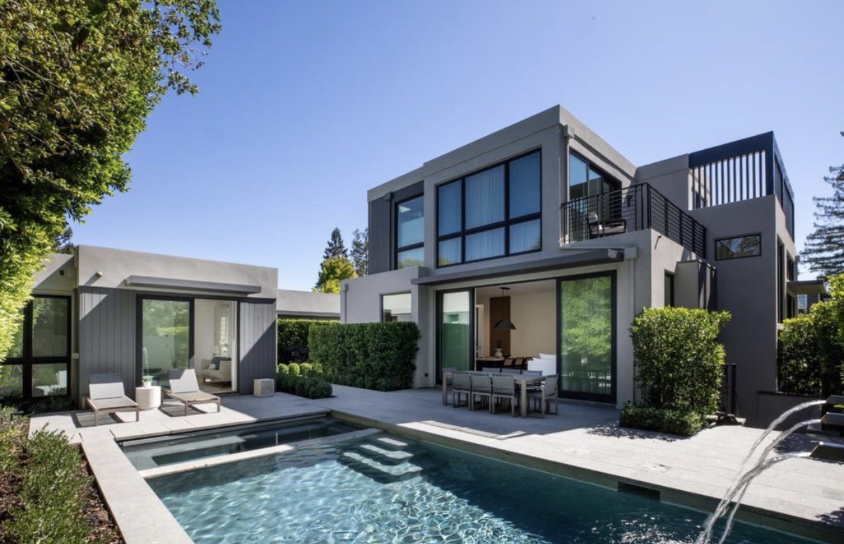 Modern home exterior renovation with pool and outdoor dining area