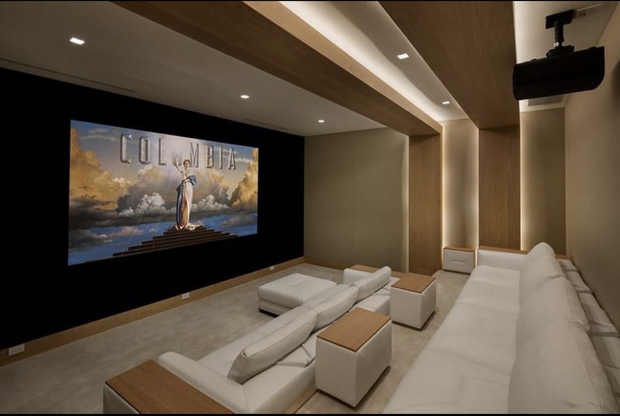 Private home theater with integrated wood lighting and seating
