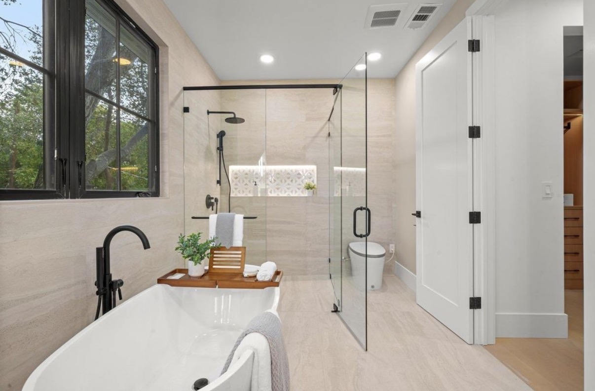 Spa bathroom with freestanding tub, black-framed windows and frameless glass shower