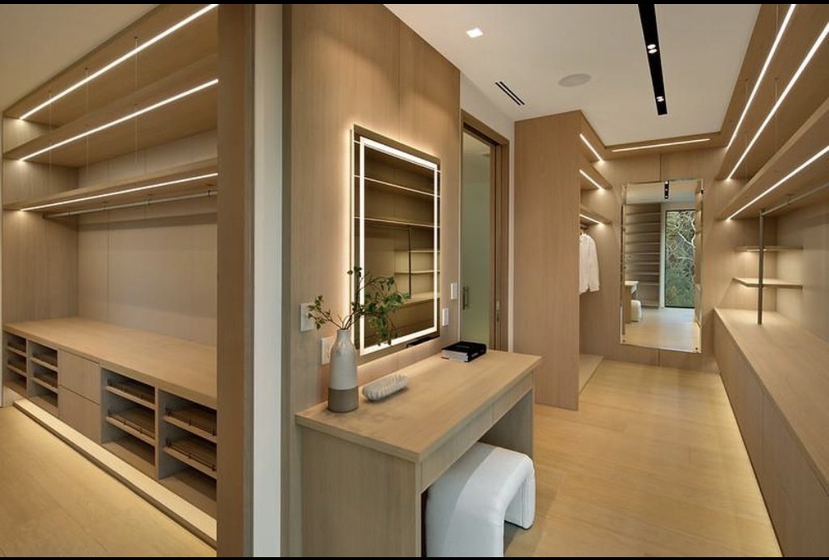 Bespoke walk-in wardrobe with integrated lighting and custom millwork