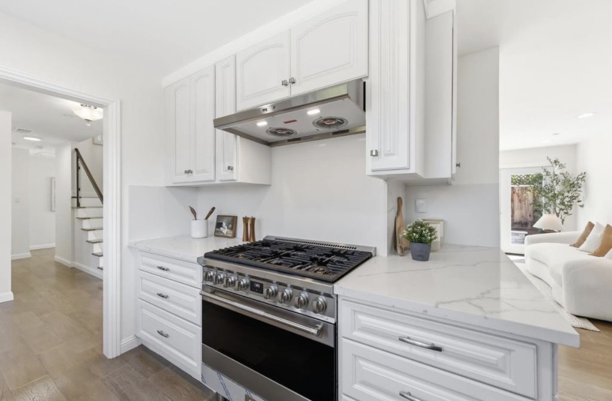 Detailed custom kitchen cabinetry surrounding a professional stainless steel range