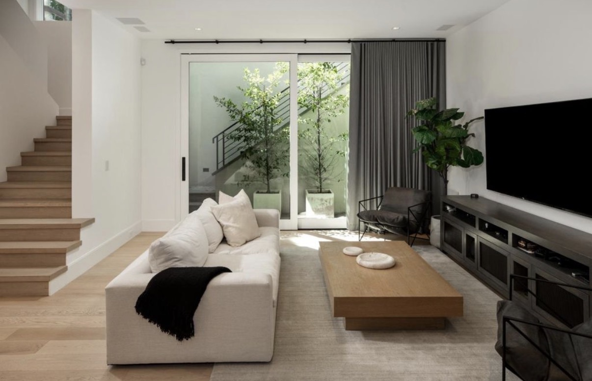 Contemporary living room with custom media cabinetry and garden courtyard