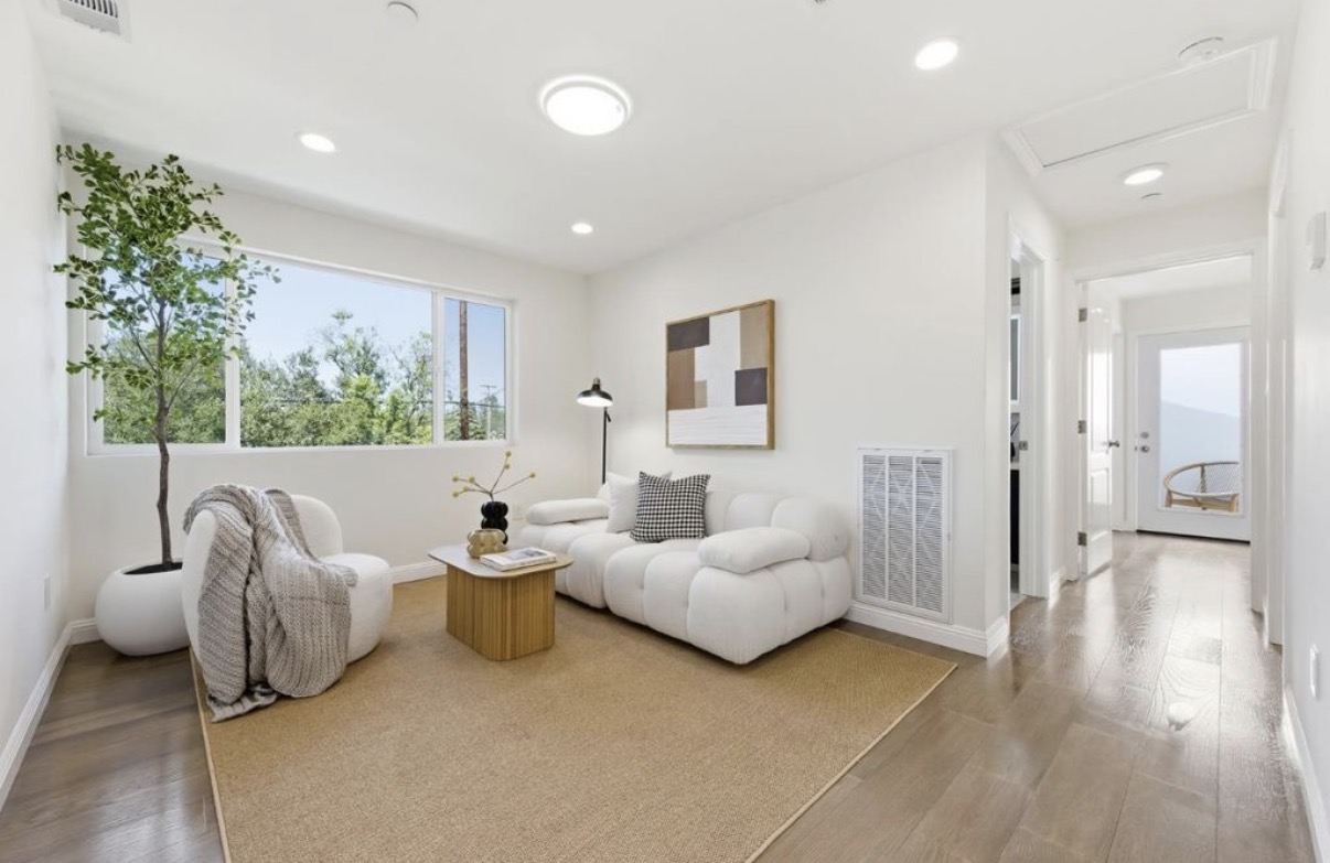 Light-filled sitting room with tailored furnishings and wide-plank floors